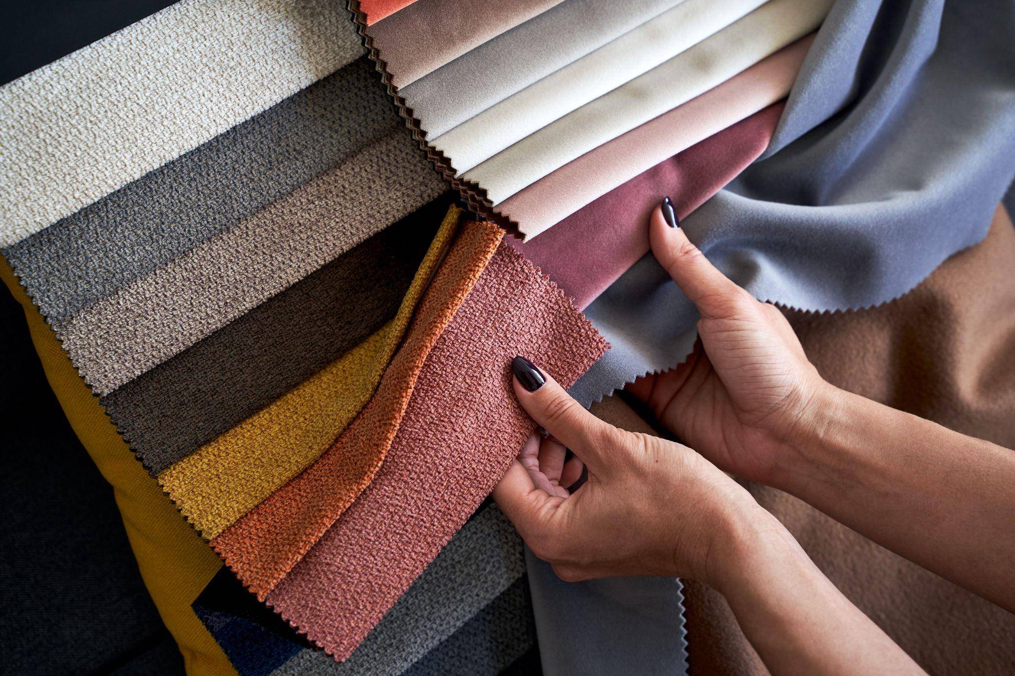 Woman going over a variety of fabric options for pillows